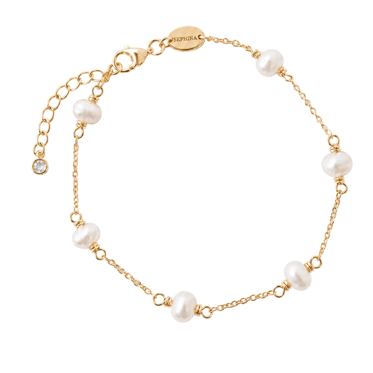 A delicate gold chain bracelet featuring 6 freshwater pearl beads spaced along the chain, displayed on a textured white background.