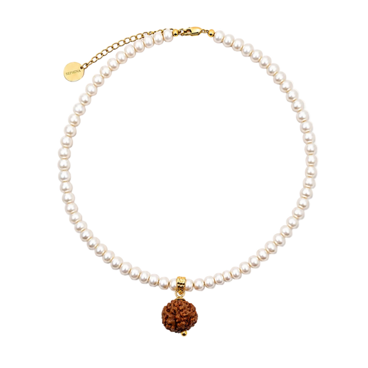 A Sephina freshwater pearl necklace with a gold clasp and extender chain, featuring a mukhi 7 pendant.